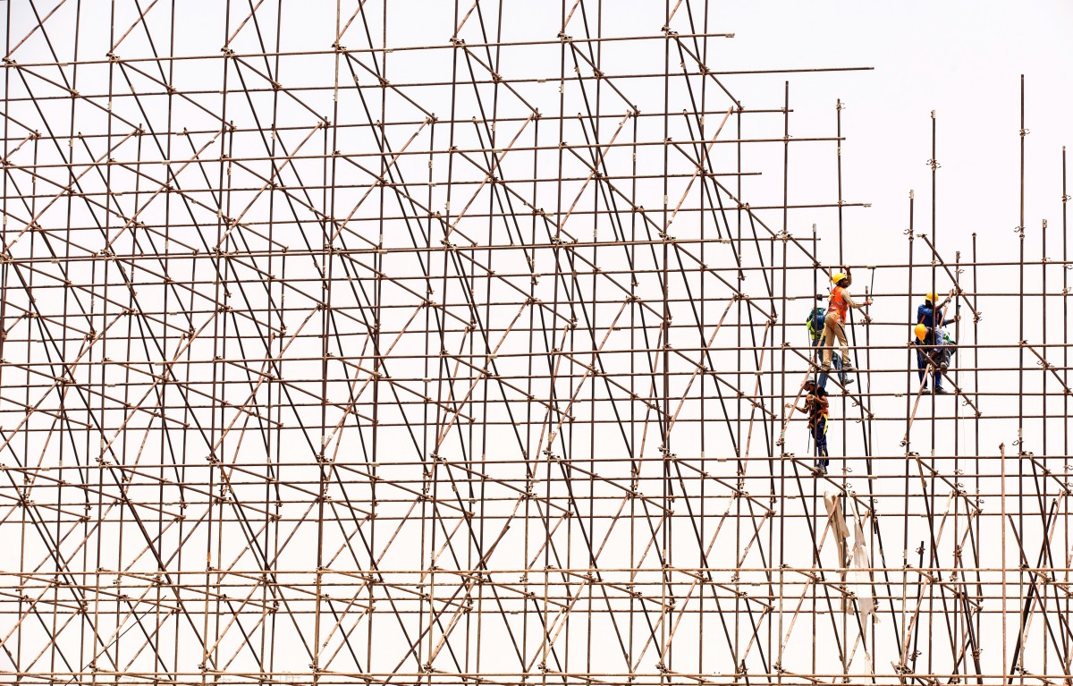 Fair Labor in Construction article. Photo of Construction Workers on Scaffolding